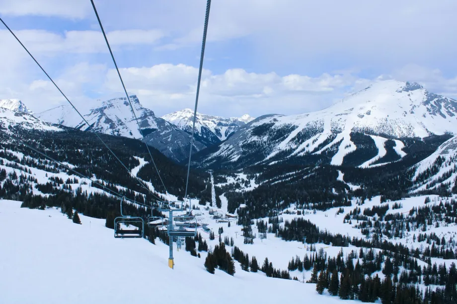 Chairlift climbing a snowy mountain slope